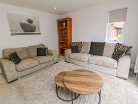 A living room with a sofa and coffee table at Wyvill House in Cayton