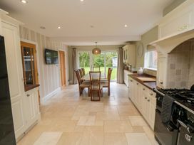 A kitchen with a dining table and chairs at Wyvill House in Cayton
