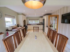 A kitchen with a dining table and chairs at Wyvill House in Cayton