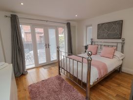 A bedroom with a bed and curtains at Wyvill House in Cayton