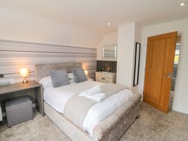 A bedroom with a bed and desk at Wyvill House in Cayton