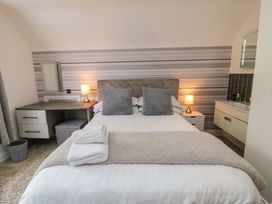 A bedroom with a bed and desk at Wyvill House in Cayton