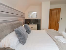 A bedroom with a bed and a cabinet at Wyvill House in Cayton
