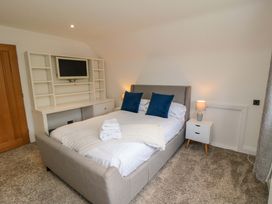 A bedroom with a bed and shelving unit at Wyvill House in Cayton