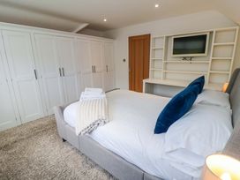 A bedroom with a bed and wardrobe at Wyvill House in Cayton
