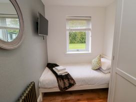 A bedroom with a single bed and TV at Wyvill House in Cayton