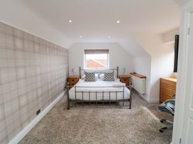 A bedroom with a bed and side tables at Wyvill House in Cayton