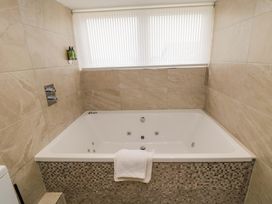 A hot tub with a towel beside it at Wyvill House in Cayton
