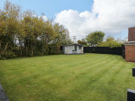 A garden with a shed and trees at Wyvill House in Cayton