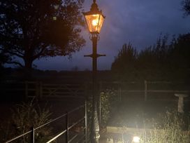 A lamp post illuminating a garden area at High House in Southrepps