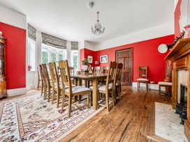 A dining room with a large table and chairs at High House in Southrepps