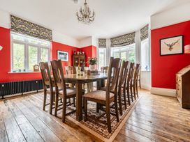 A dining room with a large table and chairs at High House in Southrepps