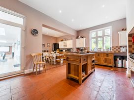 A kitchen with cabinets and dining area at High House in Southrepps