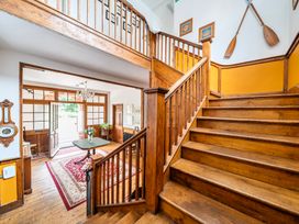 An entrance hall with a staircase and a door to the outside at High House in Southrepps