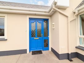 A blue door with window panels and a light fixture at 29 Church Field Doonbeg, County Clare