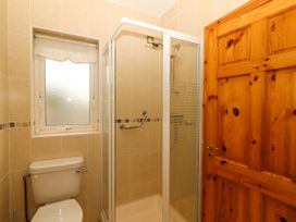 A bathroom with a shower and toilet at 29 Church Field Doonbeg, County Clare