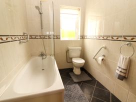 A bathroom with a bathtub and toilet at 29 Church Field, Doonbeg, County Clare