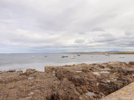 A view of the sea with rocks and boats at 29 Church Field in Doonbeg, County Clare