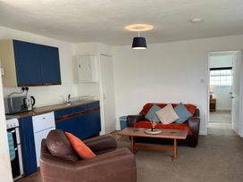 A living room with a sofa and coffee table at Min Y Mor Llanystumdwy near Criccieth