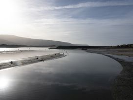 A coastal scene with water channels sandbanks and hills in the background at Harbour View Flat 2 in Barmouth