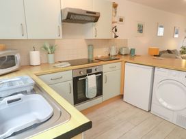 A kitchen with appliances and fixtures at Driftwood in Marazion