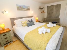 A bedroom with a double bed and nightstand at Driftwood in Marazion