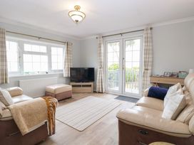 A living room with a sofa and television at Seaward in Trimingham