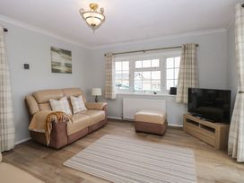 A living room with a sofa and television at Seaward in Trimingham