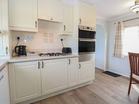 A kitchen with cabinets and a gas stove at Seaward in Trimingham