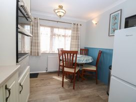 A kitchen with a dining table and chairs at Seaward in Trimingham