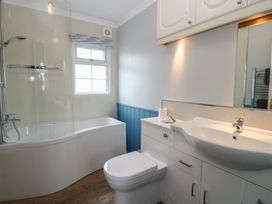 A bathroom with bathtub and shower at Seaward in Trimingham