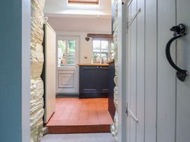 A kitchen entry with cabinets and a window at Preswylfa in Ffestiniog
