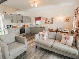 A kitchen with appliances and seating at Carthouse in Brean