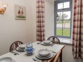 A dining room with a table set for meals at Carthouse in Brean