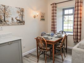 A dining room with a table and chairs at Carthouse in Brean