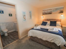 A bedroom with a bed and access to a bathroom at Carthouse in Brean