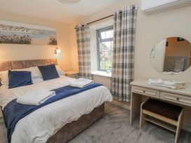 A bedroom with a bed and desk at Carthouse in Brean