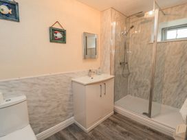 A bathroom with a toilet, sink, and shower at Carthouse in Brean