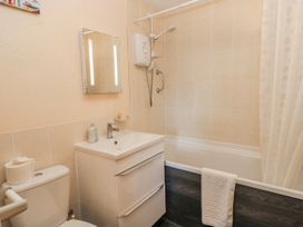 A bathroom with sink, toilet, shower and bathtub at Carthouse in Brean