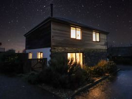 A house with lights on at night at 3 Praa Cove in Praa Sands