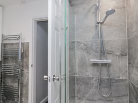 A bathroom with a shower and towel radiator at Hazelodge in Coniston