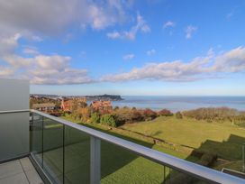 A view from a balcony overlooking the ocean and houses at The Lookout