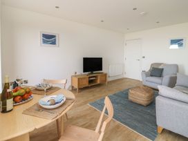 A living room with a table and sofa at The Lookout