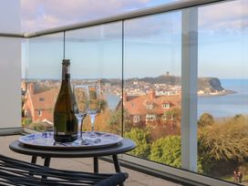 A bottle and glasses on a table with a view at The Lookout