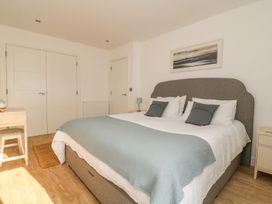 A bedroom with a bed and bedside table at The Lookout