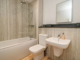 A bathroom featuring a bathtub, shower, toilet, and sink at The Lookout