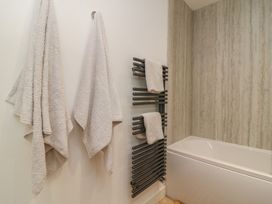 A bathroom with towels on a rack and bath at The Lookout 
