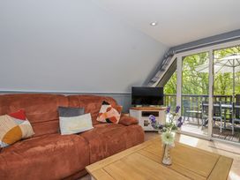 A living room with a sofa and television at Hideaway Cottage, St Ann's Chapel, Cornwall