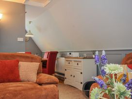 A living room with a sofa and table at Hideaway Cottage St Ann's Chapel, Cornwall