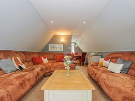A living room with a sofa and coffee table at Hideaway Cottage, St Ann's Chapel, Cornwall
